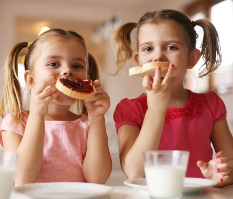 Girls eating bread with jam